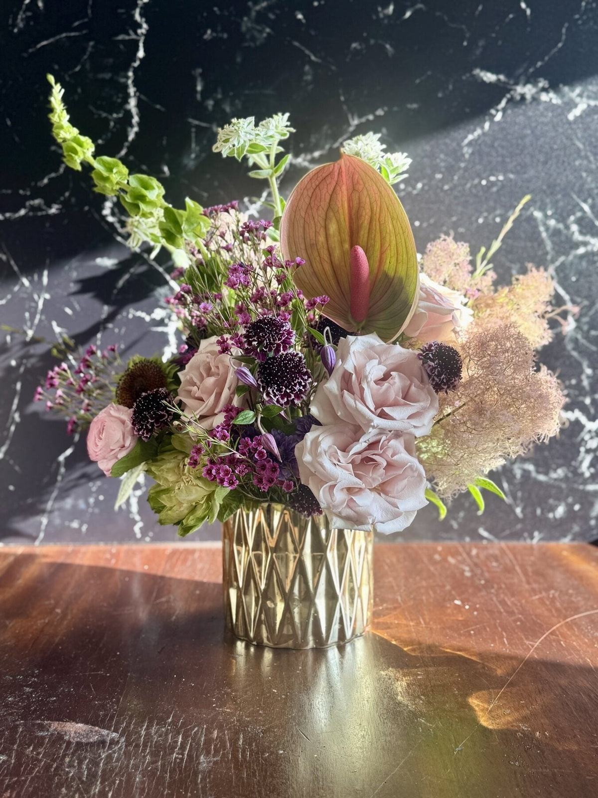 The Muse Collection: a colorful seasonal arrangement in a gold vase